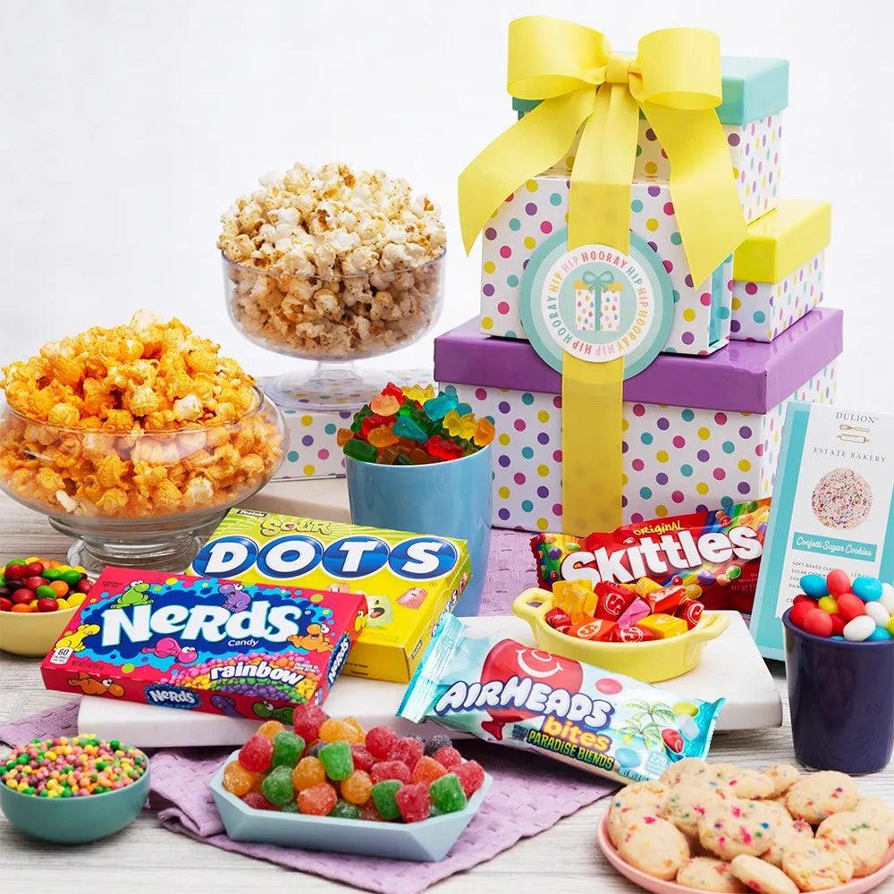 Say “Happy Birthday” with this festive birthday-themed gift tower. Bright and cheery boxes are filled with our favorite birthday celebration treats. To please their sweet tooth, we’ve artfully arranged gourmet popcorn and fruity candy inside the box tiers. This gift is sure to make their birthday a memorable one!
