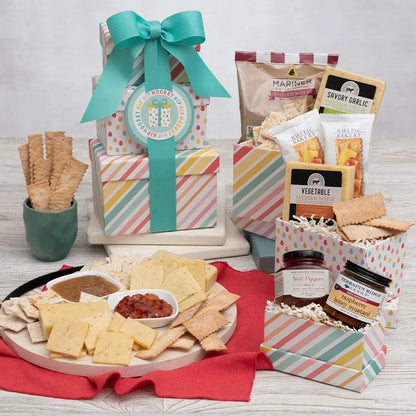 Our gourmet gift creators designed a celebratory striped and dot birthday tower and filled it with olive oil flatbread crackers, stoned wheat crackers, two flavors of cheese, raspberry honey mustard, and hot pepper jelly. The added condiments and the unique basics make for a delicious snacking experience. Send someone Happy Birthday wishes today!   