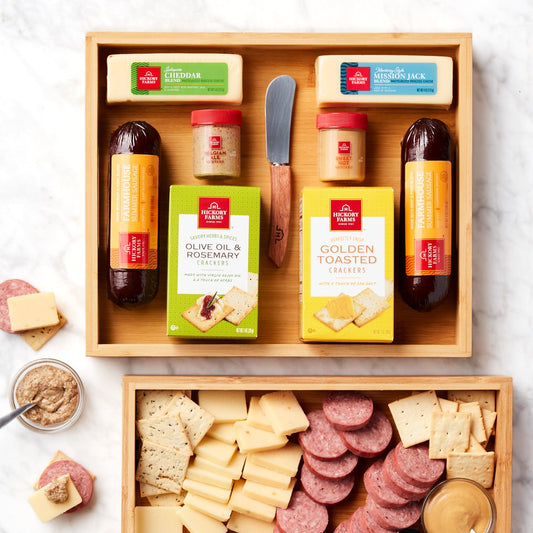 Festive Charcuterie Bamboo Gift Set - This festive meat and cheese gift set is perfect for anyone on your list who loves to entertain with a delicious charcuterie board! The reusable bamboo tray comes with sausages, cheese, mustards, and crackers to create savory bites. And the cheese spreader makes serving easy