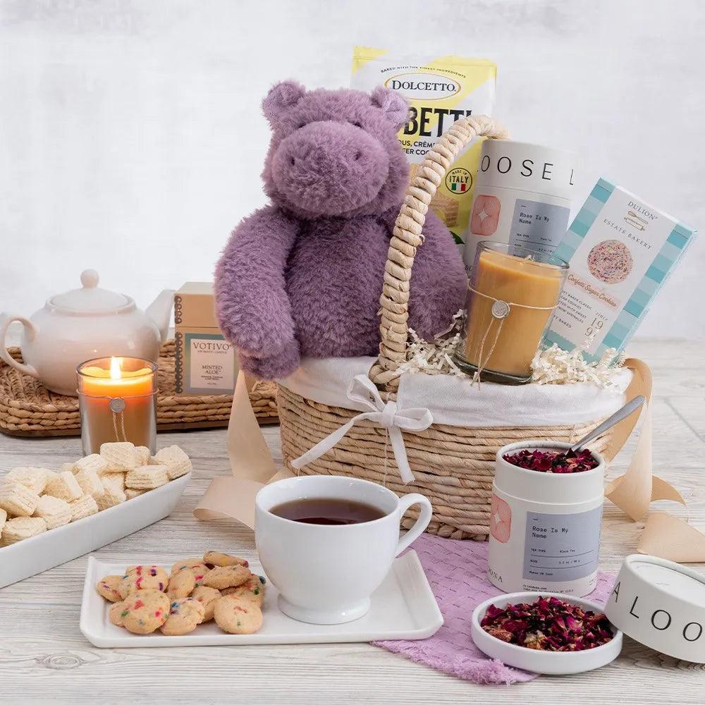 Say goodbye to stress and hello to comfort with our Hippo of Well Wishes Gift Basket! This adorable purple plush hippo is the perfect companion for anyone not feeling well or in need of a hug. They'll enjoy relaxing while lighting the soothing minted aloe candle and enjoying a warm cup of tea accompanied by delicious cookies. Show that you care with this thoughtful and comforting gift. Order now and bring a smile to someone's face today.