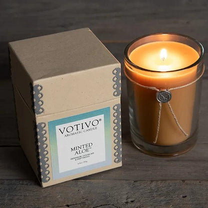 Votivo Aromatic Candle - Minted Aloe - Minted Aloe is the relaxing escape you've been looking for. Clean, refreshing notes of peppery mint, lavender, and chamomile blend with geranium and sandalwood for a soft, soothing fragrance that evokes feelings of peace and tranquility. Every Votivo candle is meticulously crafted with a proprietary soy-blend wax formulation that ensures a clean, even burn and a memorable, one-of-a-kind fragrance experience. Approx. 60 hour burn time. 