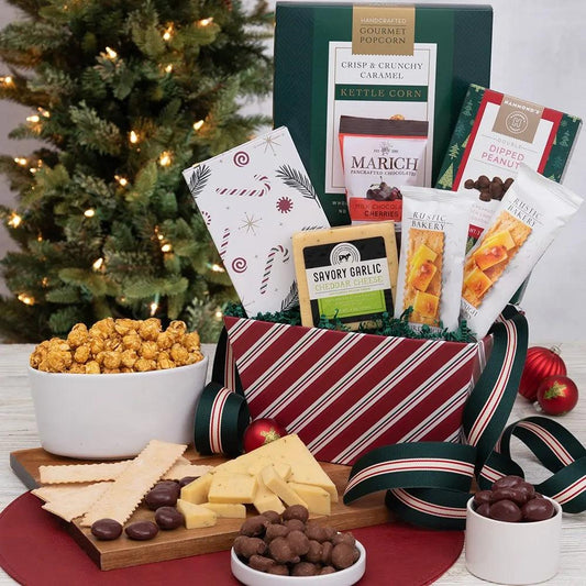Spread holiday cheer with our Holiday Cheese and Cracker Snacker Gift Basket! Packed with delicious surprises, this is the perfect Christmas or holiday gift.  Treat your loved ones to a mouthwatering assortment of creamy cheese, crispy crackers, delicious freshly popped popcorn, chocolate-covered cherries, and double-dipped peanuts.