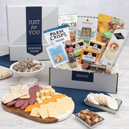 Our Just For You! Savory Deluxe Gift Box is a hearty care package filled with all the  accompaniments needed to create their own charcuterie board. Including multigrain flatbread crackers, protein snack mix, three different cheese flavors, summer and garlic sausages, mixed nuts, and cookies! Your gift recipient will be more than excited to tear into this deluxe gift.