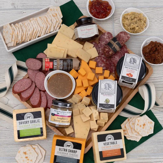 This Meat and Cheese Artisano Gift Tray Platter features a carefully selected assortment of gourmet meats, artisan cheeses, crackers, and antipasto items. From Finocchiona to summer sausage, to creamy cheese, to Artichoke Bruschetta, and gourmet preserves, this is the perfect host or hostess gift for any occasion. Arrives nestled in a wooden cutting board, ready for immediate use!