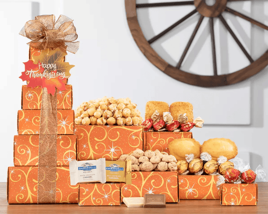 Thanksgiving Celebration Gift Tower - Send thanks with this delightful gift tower, packed with warm wishes and great tasting treats. Belvaux chocolate truffles, Lindt Lindor milk chocolate truffle balls, lemon cakes, Shell Bella madeleine cakes, Socado milk chocolate tiramisu truffles, Ghirardelli chocolate squares, almond cookies and caramel popcorn are brought together for this fall assortment.   